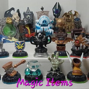 Skylander Magic Items; Sparx Dragonfly, Hidden Treasure, Kaos Trophy, Piggy Bank, Darklight Crypt and more.