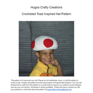 May include: A child wearing a crocheted white and red mushroom hat. The hat is inspired by the Super Mario Bros. video game character, Toad. The child is smiling and holding a small orange pumpkin.