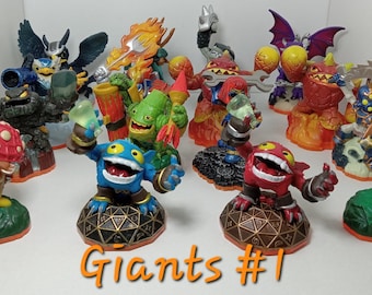 May include: A collection of 11 colorful Skylanders Giants figures, including a red and black figure with a red mouth, a blue figure with a green head, and a green figure with a red mushroom on its head. The figures are standing on a variety of bases, including a green base with a skull, a red base with flames, and a brown base with a tree. The figures are all in various poses, and some are holding weapons. The text "Giants #1" is written in orange at the bottom of the image.