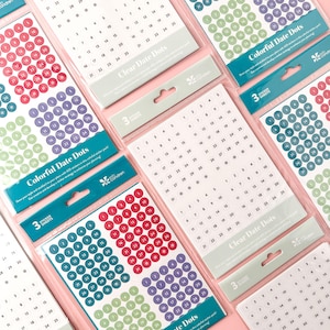 May include: Multiple sticker sheets with colorful date dots in various colors, including red, purple, green, and clear. Each sheet contains numbered circles for planning and organization. The packaging includes the text "Colorful Date Dots" and "Clear Date Dots".
