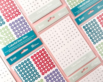 May include: Multiple sticker sheets with colorful date dots in various colors, including red, purple, green, and clear. Each sheet contains numbered circles for planning and organization. The packaging includes the text "Colorful Date Dots" and "Clear Date Dots".