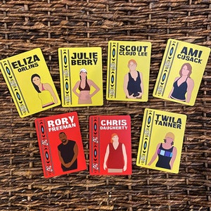 May include: A set of nine yellow and red cards with illustrations of people and their names. The names on the cards are Eliza Orlins, Julie Berry, Scout Cloud Lee, Cami Cusack, Rory Freeman, Chris Daugherty, Twila Tanner.