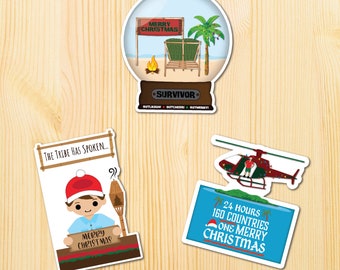 May include: Four Christmas-themed stickers featuring the popular reality TV show Survivor. The stickers feature a snow globe with a beach scene, a helicopter, a character holding a sign that says "The Tribe Has Spoken..." and a sign that says "24 Hours 160 Countries One Merry Christmas".