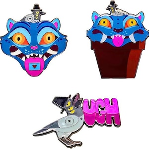 Peut inclure: Trois épingles émaillées : une tête de chat bleue avec une langue rose et un cœur, une tête de chat bleue dans un pot marron et un oiseau gris avec le mot "UGH" en rose. Chaque épingle a un design et une palette de couleurs uniques.