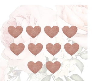 May include: Ten rose gold heart stickers with a glitter finish. The stickers are arranged in a grid pattern on a white background with a floral design.