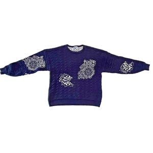 May include: A dark blue long-sleeve sweatshirt with a textured, crinkled fabric surface. The garment features white, intricate, circular geometric patterns printed on the chest and sleeves, with a white lace-like trim visible at the inner neckline.