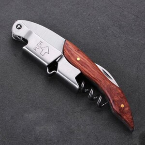 a knife with a wooden handle on a black surface