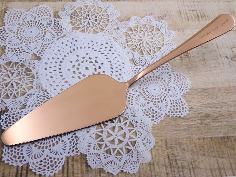 a gold serving spoon on a white doily