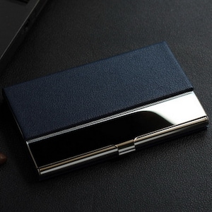 a black business card case sitting on top of a desk