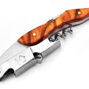 May include: A stainless steel waiter's corkscrew featuring a handle with a polished amber-colored wood grain pattern and two brass rivets. The metal body includes a folding spiral worm, a lever arm, and the word PUSH with an upward-pointing arrow.