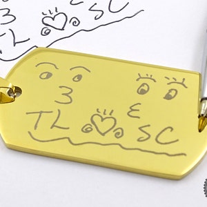 a close up of a key chain with a drawing on it