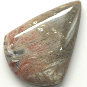 May include: A polished, teardrop-shaped gemstone with a complex pattern of red, gray, and white veining. The stone has a glossy surface and a smooth, rounded shape, ideal for jewelry or collection.