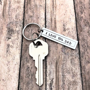 May include: Silver key ring with a silver key and a silver tag that says "I love you Dad".