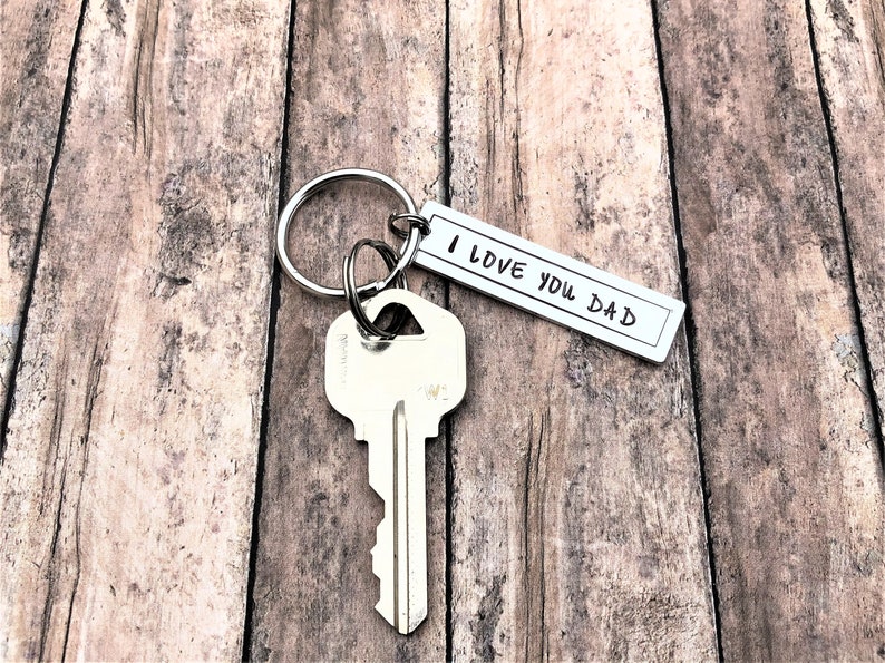 May include: Silver key ring with a silver key and a silver tag that says "I love you Dad".