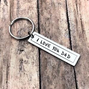 May include: Silver keyring with a rectangular tag that reads "I love you Dad".