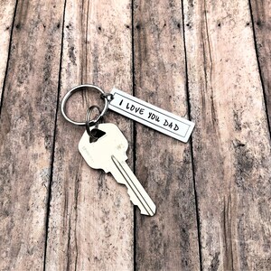 May include: Silver keyring with a key and a tag that says "I love you Dad".