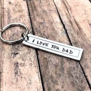 May include: Silver keyring with a rectangular tag that reads "I love you Dad".