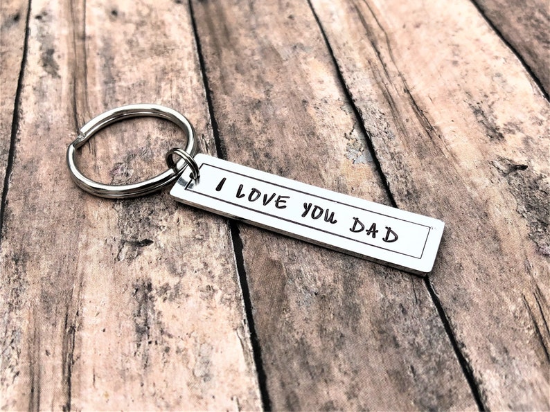 May include: Silver keyring with a rectangular tag that reads "I love you Dad".