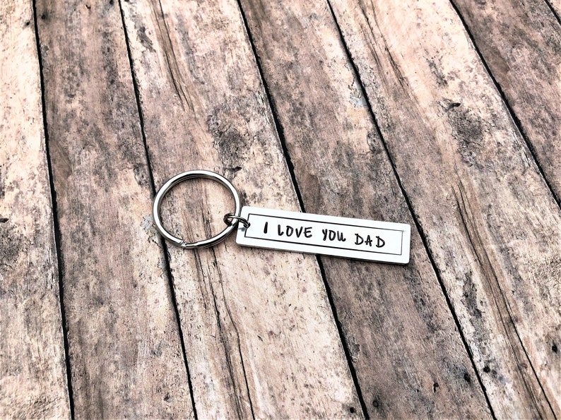 May include: Silver keyring with a rectangular tag that reads "I LOVE YOU DAD".