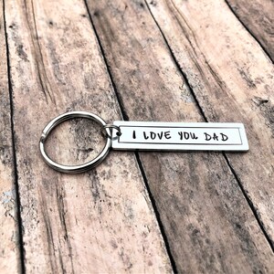 May include: Silver keyring with a silver tag that reads "I LOVE YOU DAD".