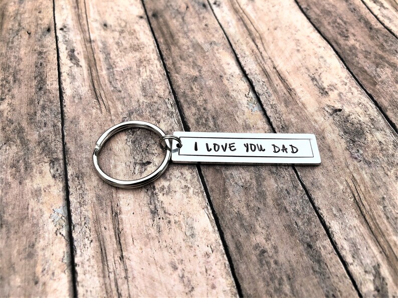 May include: Silver keyring with a silver tag that reads "I LOVE YOU DAD".