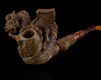 May include: A wooden pipe carved in the shape of a dragon. The pipe is brown and has intricate details. The bowl of the pipe is round and has a floral design.
