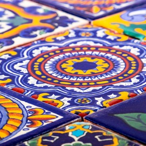 May include: Close-up of colorful ceramic tiles with intricate geometric patterns in shades of blue, red, yellow, and white.