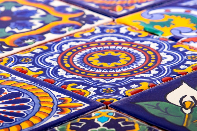 May include: Close-up of colorful ceramic tiles with intricate geometric patterns in shades of blue, red, yellow, and white.