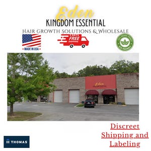 May include: Exterior view of a brick building with a red awning that says "Eden Kingdom Essential". The building has several large garage doors and a small car parked in front. The image also includes a logo with the text "Eden Kingdom Essential" and the words "Hair Growth Solutions & Wholesale".