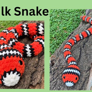 May include: A plush, handmade milk snake toy. The snake features a vibrant pattern of red, black, and white stripes. The head is detailed with black eyes and a white mouth. The text "Milk Snake" is at the top of the image.