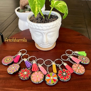 Dot mandala & flower design keychains on wooden discs painted with acrylic paint and coated with varnish, decorated with beautiful tassels