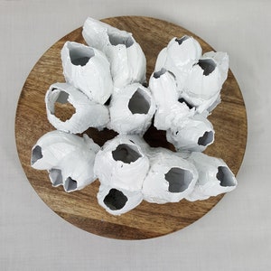 May include: White ceramic sculpture of a cluster of coral-like forms on a wooden base.