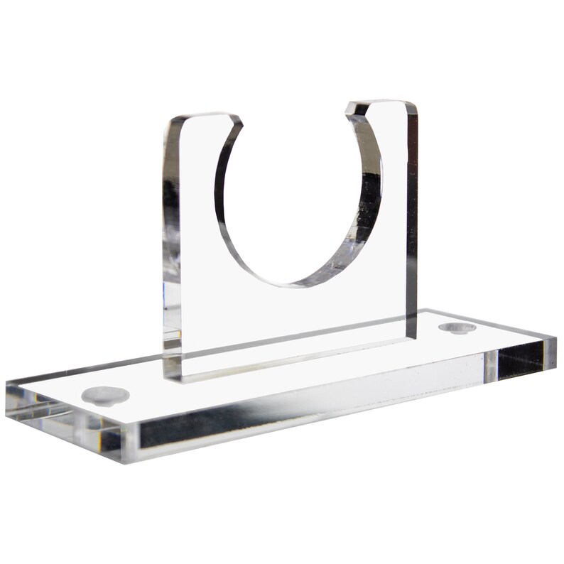 May include: Clear acrylic display stand with a circular cutout for holding a sword or other object. The stand has a rectangular base with two small screws on the bottom.
