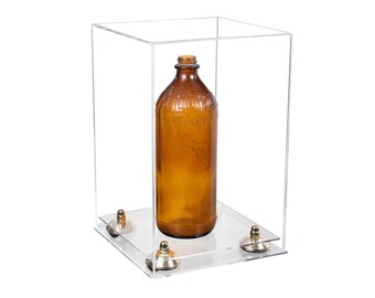 May include: A clear acrylic display case with a vintage amber glass bottle inside. The bottle has a narrow neck and a rounded body. The case sits on a white surface.
