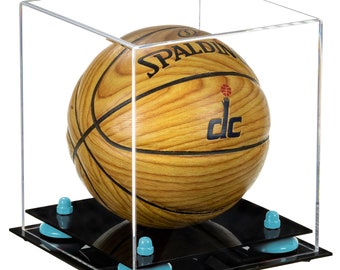 May include: A clear acrylic display case with a black base and four blue rubber feet. Inside the case is a brown and black basketball with the word "SPALDING" and the letters "DC" printed on it.