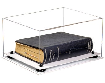 May include: A clear acrylic display case with a black book inside. The book is titled "International Postage Stamp Album, Part 1".