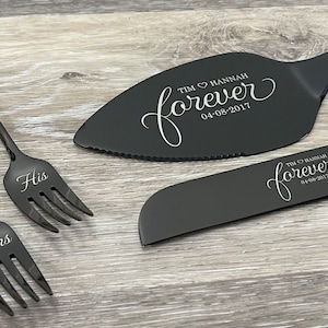 May include: Black wedding cake knife and server set with the words "Tim & Hannah forever 04-08-2017" engraved on the handles. The forks are labeled "His" and "Hers".