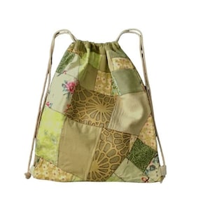 May include: A green and brown patchwork drawstring bag with floral and geometric patterns.