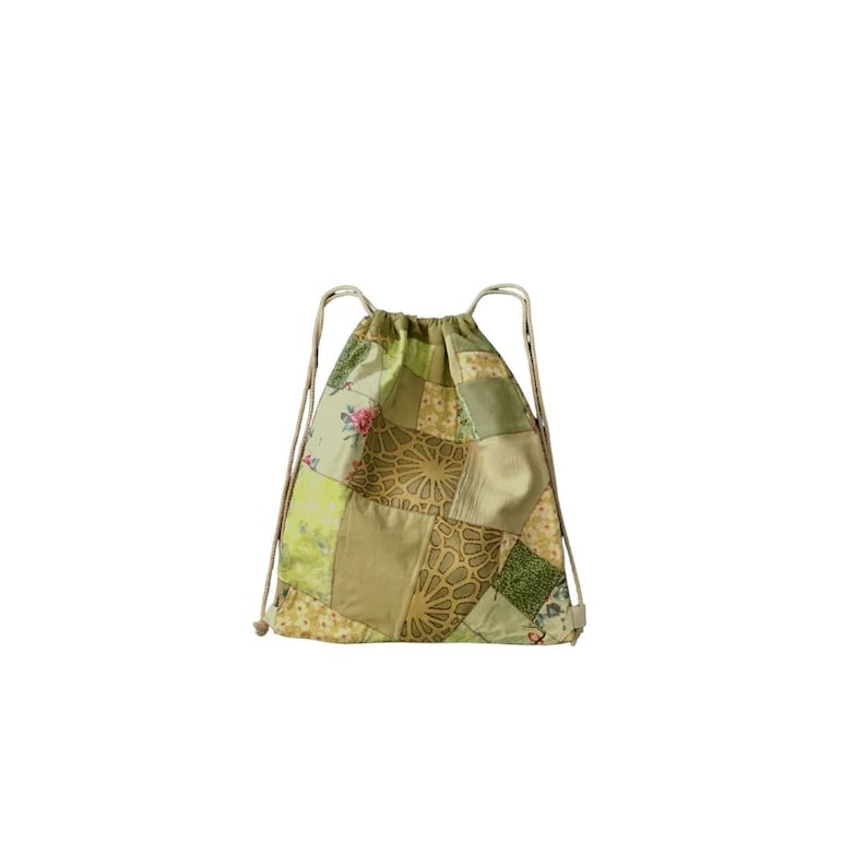 May include: A green and brown patchwork drawstring bag with floral and geometric patterns.