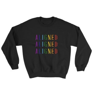 May include: Black sweatshirt with the word "ALIGNED" repeated three times in rainbow colors.