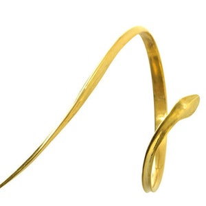 May include: A gold snake ring with a thin, curved band. The snake's head is raised and the tail wraps around the finger.