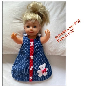 May include: A blue and white polka dot sleeping bag with a red trim and a white crocheted bear applique. The sleeping bag is designed for a doll.  Schnittmuster PDF Pattern PDF