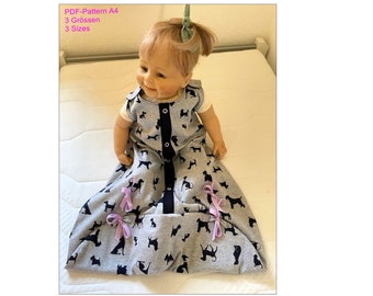 May include: A gray and black sleep sack with a black dog print. The sleep sack has a zipper down the front and purple ribbon ties at the bottom. The sleep sack is on a white mattress.