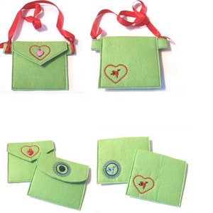 May include: Six different felt pouches with various embroidered designs. The pouches are green and white and have different shapes and sizes. Some pouches have a strap for wearing around the neck.