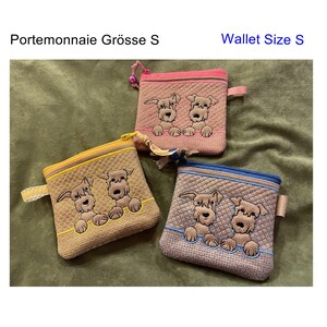 May include: Three small zippered wallets with a quilted fabric exterior. Each wallet features an embroidered design of two dogs peeking over the top. The wallets are in pink, yellow, and brown with blue trim.