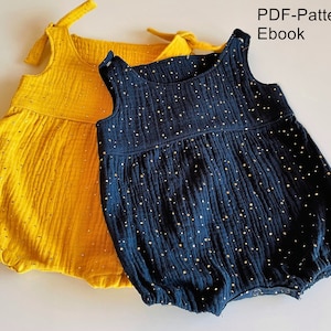 May include: Two baby onesies, one yellow and one blue, with gold glitter dots. The onesies have straps and a gathered skirt. The text "PDF-Pattern Ebook" is in the top right corner of the image.
