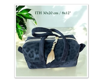 May include: A black velvet handbag with a leopard print design. The bag has a zipper closure and a top handle. It also has a detachable shoulder strap. The bag measures 30x20 cm / 8x12 inches.