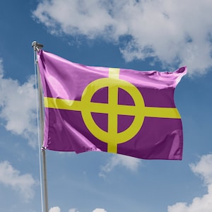 May include: A purple flag with a yellow Celtic cross in the center, waving in the wind against a blue sky with white clouds.
