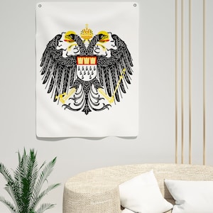 May include: A white flag featuring a black double-headed eagle with a gold crown and shield. The shield displays a red and gold design with a black eagle. The eagle is holding a sword and a sceptre.