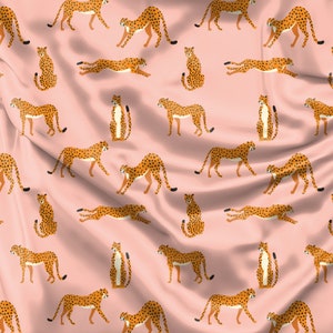 May include: A pink fabric background with a repeating pattern of brown and black cheetahs in various poses. The cheetahs are stylized and have a flat design.